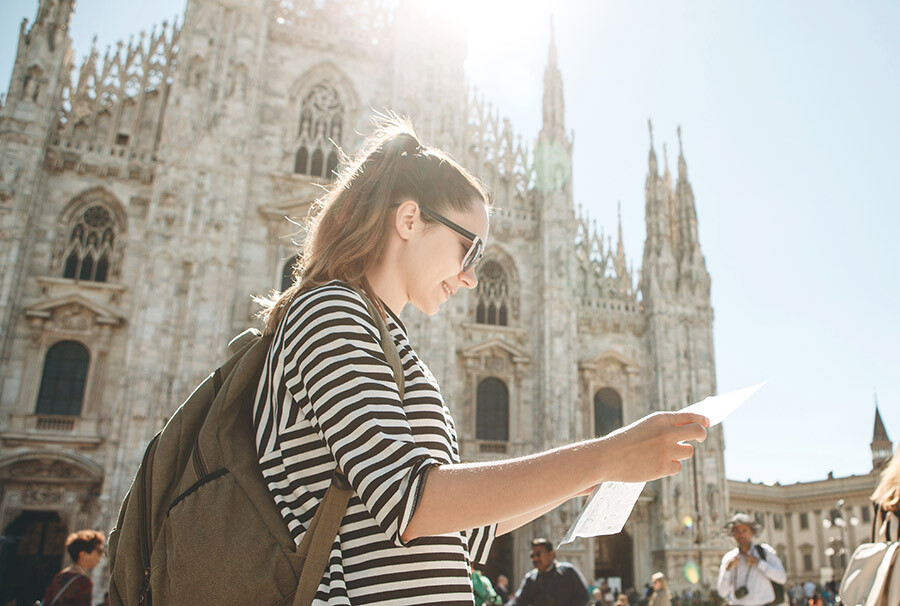 Woman standing outside of a cathedral. Study abroad with Marian University.