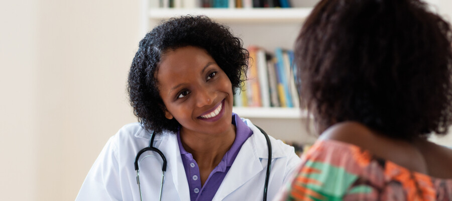 A nurse practitioner in her office consults with a patient.
