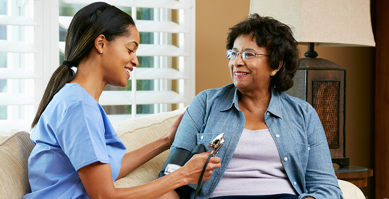 Marian University MSN graduate speaks with patient about care.