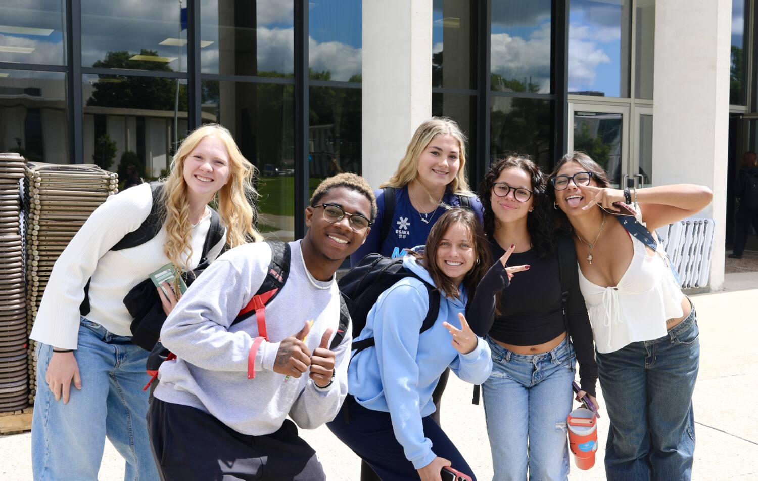 6 freshman students posing in front of the HSC building.