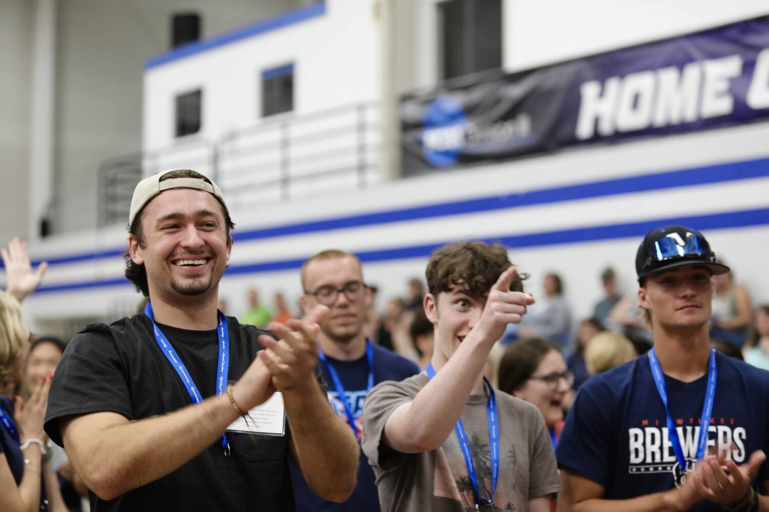 Freshman clapping, and wearing lanyards from the Marian pinning ceremony.