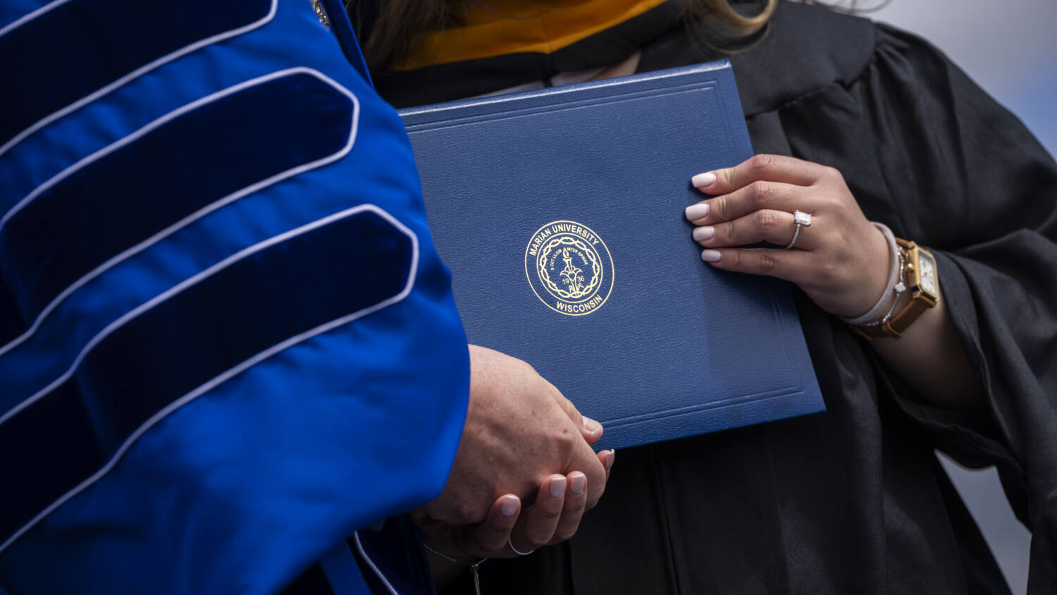 Diploma being handed over from president to a student.